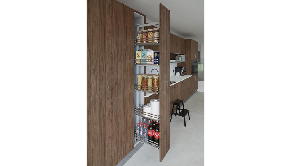 Crown Spaceworks+ larder pull-out solution is shown here in Textura Walnut natural featuring 150mm pull-outs, corner storage, and integrated waste bins. These versatile, soft-close options are available across Crown’s kitchen ranges