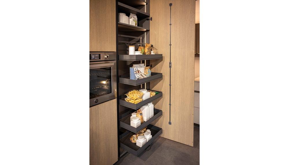 Rotpunkt’s Zerox SY VER Scandinavian Brown Oak & Zerox MA Sandy Beach kitchen features the Kesseböhmer TANDEM pull-out larder, connecting the furniture and storage elements in one fluid motion. Includes 3-sided access, height-adjustable trays, and smooth-running rail technology for one-handed operation